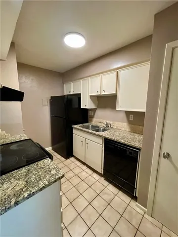 a kitchen with a sink stove and refrigerator