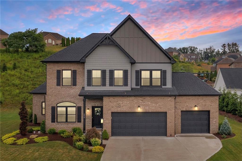 a front view of a house with a yard and garage