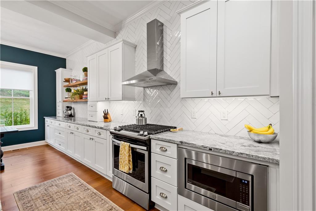 406 Silver Crest Drive Venetia, PA 15367 - Photo 4 of 25 a kitchen with stainless steel appliances granite countertop a stove and a white cabinets