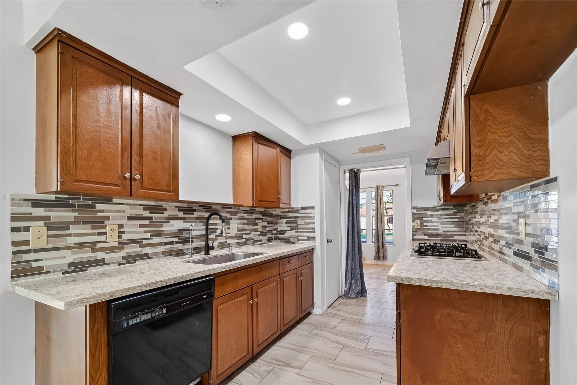 10706 Sagebluff Drive Houston, TX 77089 - Photo 6 of 19 a kitchen with stainless steel appliances granite countertop a stove and a sink