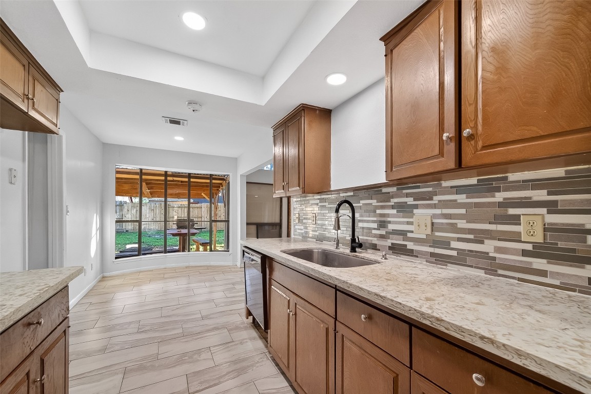 10706 Sagebluff Drive Houston, TX 77089 - Photo 7 of 19 a kitchen with granite countertop a sink and cabinets