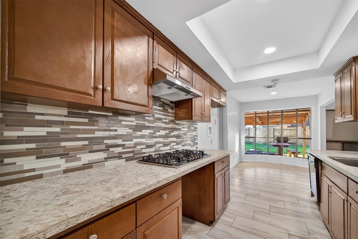 10706 Sagebluff Drive Houston, TX 77089 - Photo 8 of 19 a kitchen with stainless steel appliances granite countertop a stove and a sink