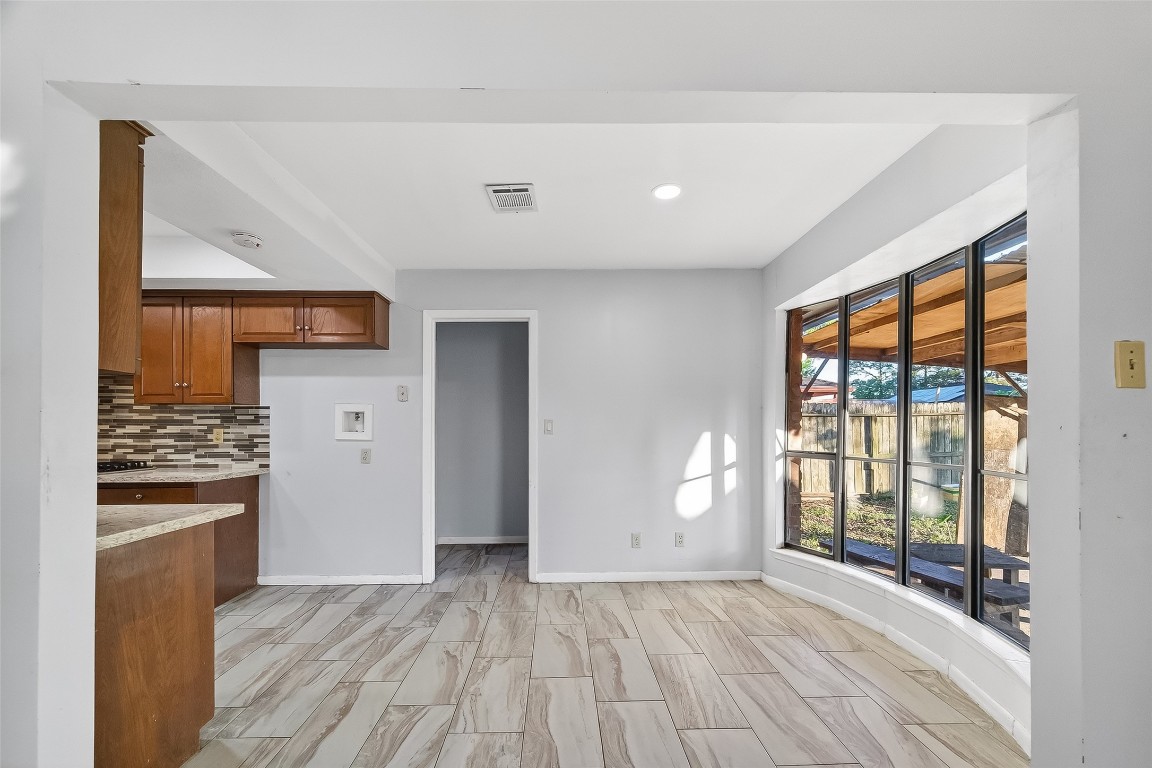 10706 Sagebluff Drive Houston, TX 77089 - Photo 9 of 19 a view of a kitchen with wooden floor and electronic appliances