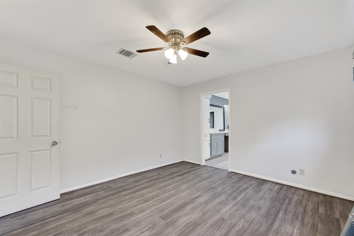 10706 Sagebluff Drive Houston, TX 77089 - Photo 10 of 19 an empty room with wooden floor and ceiling fan