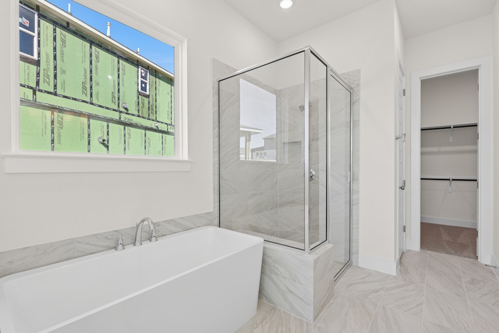 19512 Judys View Pflugerville, TX 78660 - Photo 13 of 38 a bathroom with a bathtub and a shower