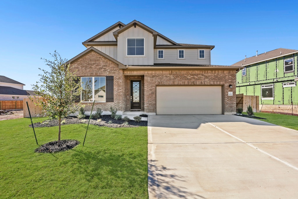 19512 Judys View Pflugerville, TX 78660 - Photo 2 of 38 a front view of a house with a yard