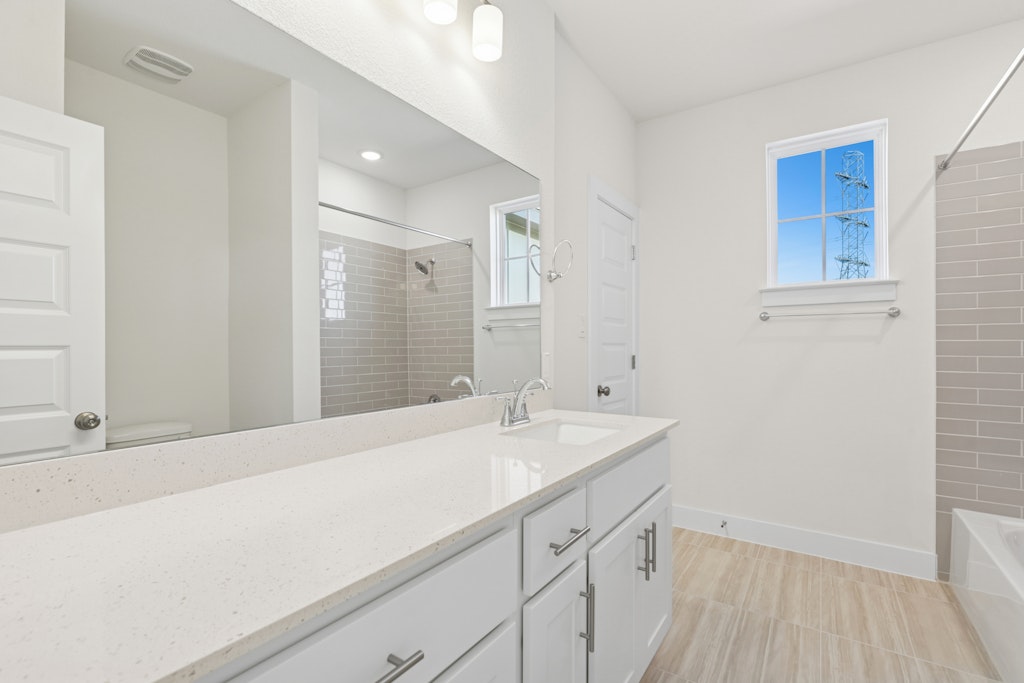 19512 Judys View Pflugerville, TX 78660 - Photo 26 of 38 a bathroom with a sink and a mirror
