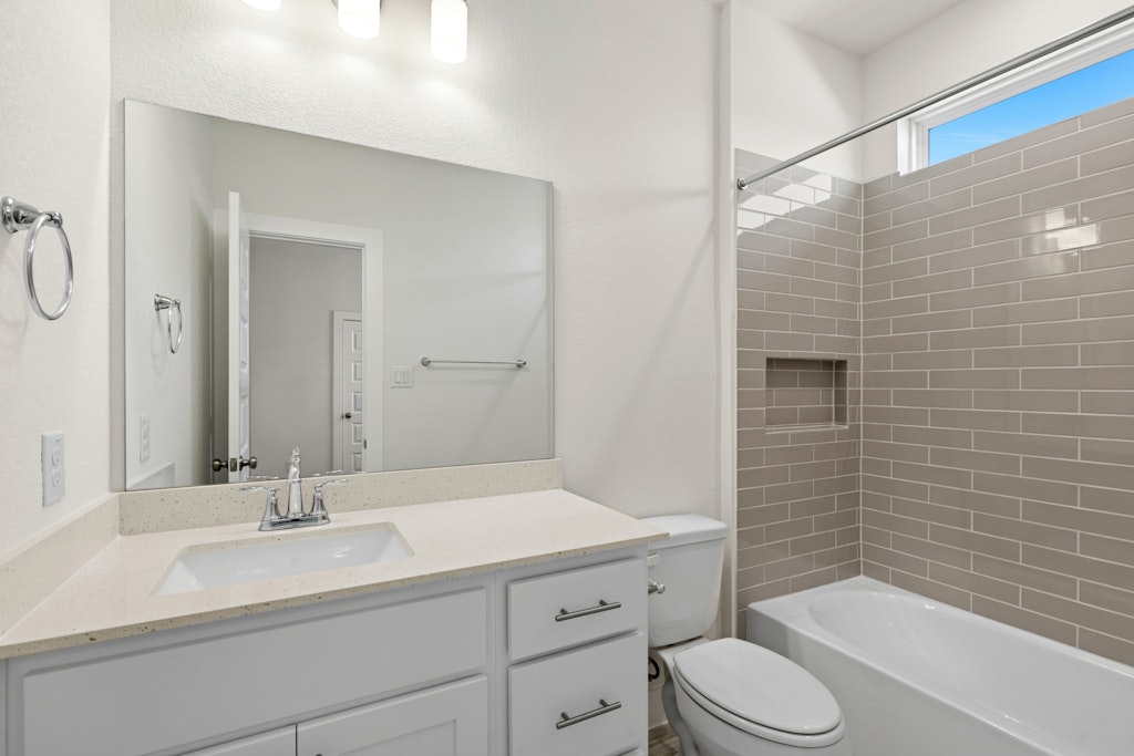 19512 Judys View Pflugerville, TX 78660 - Photo 31 of 38 a bathroom with a sink a toilet and shower