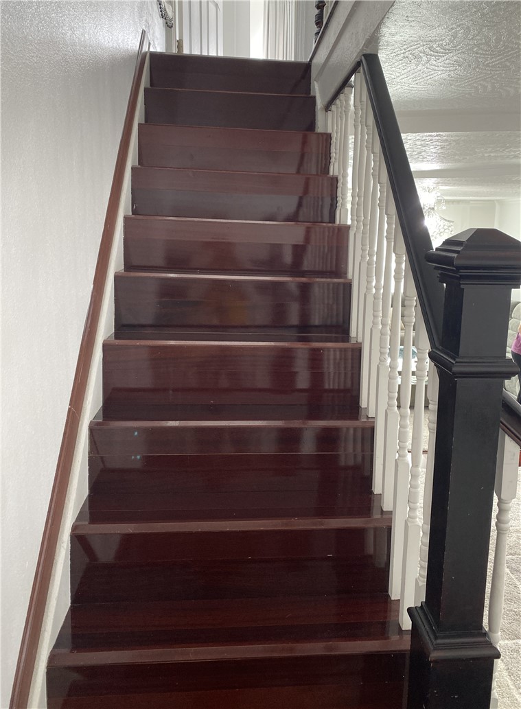 175 Rita Street Dayton, OH 45404 - Photo 5 of 48 This interior features a rich wooden staircase with a classic white baluster.