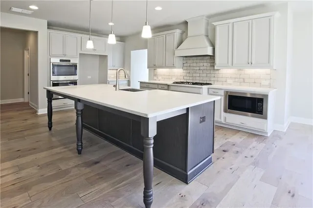 a kitchen with a stove a sink and a refrigerator