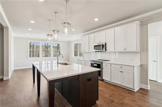 a kitchen with a stove sink and microwave