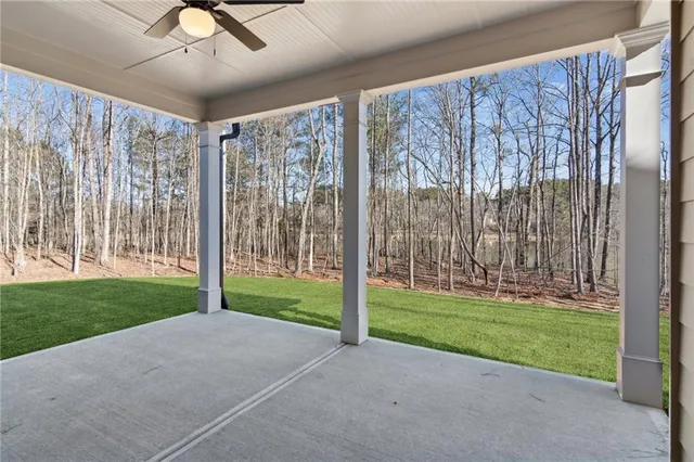 a view of a porch with a big yard and large trees