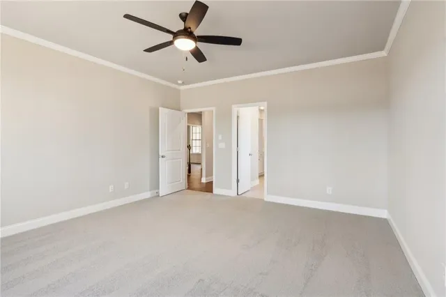 an empty room with ceiling fan and window