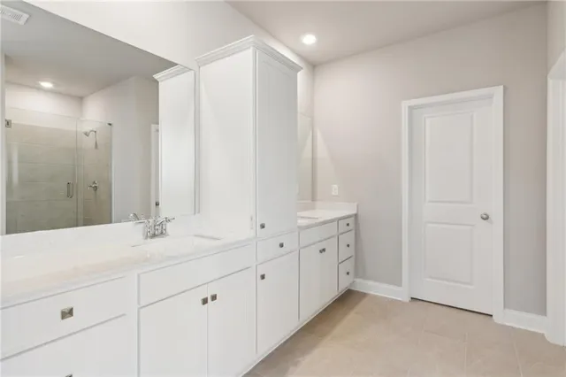 a bathroom with double sink and a mirror