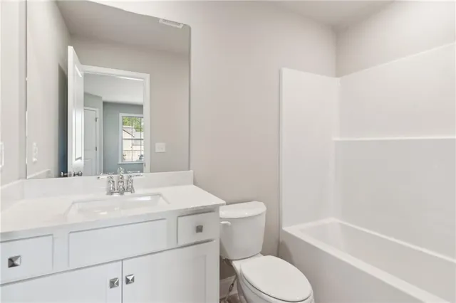 a bathroom with a sink toilet and vanity