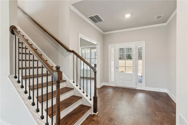 a view of an entryway with wooden floor
