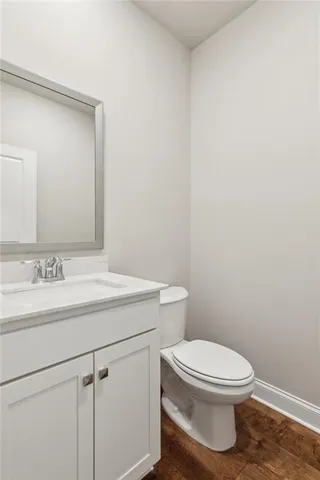 a bathroom with a toilet a sink and vanity