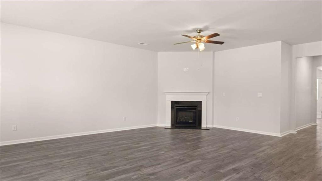 88 White Spruce Way Newnan, GA 30265 - Photo 17 of 20 a view of empty room with wooden floor and fan