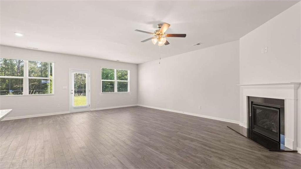 88 White Spruce Way Newnan, GA 30265 - Photo 19 of 20 a view of an empty room with wooden floor and a window