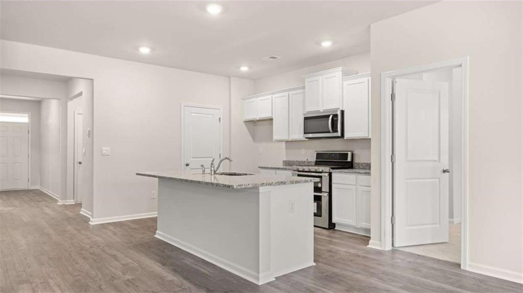 88 White Spruce Way Newnan, GA 30265 - Photo 2 of 20 a kitchen with kitchen island a sink stainless steel appliances and cabinets