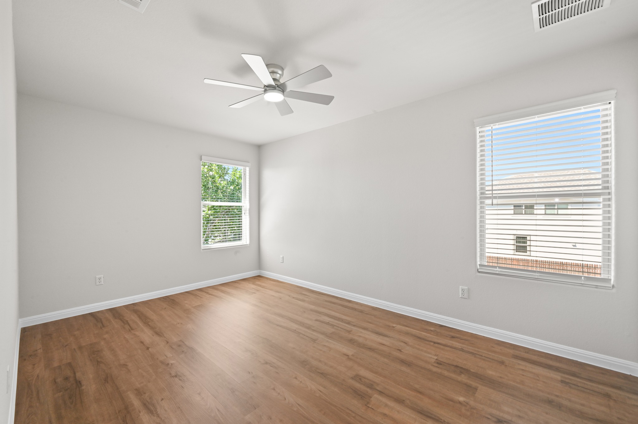 351 Wincliff Drive Buda, TX 78610 - Photo 30 of 40 A well-lit bedroom features durable hardwood flooring and a convenient ceiling fan for ultimate comfort.