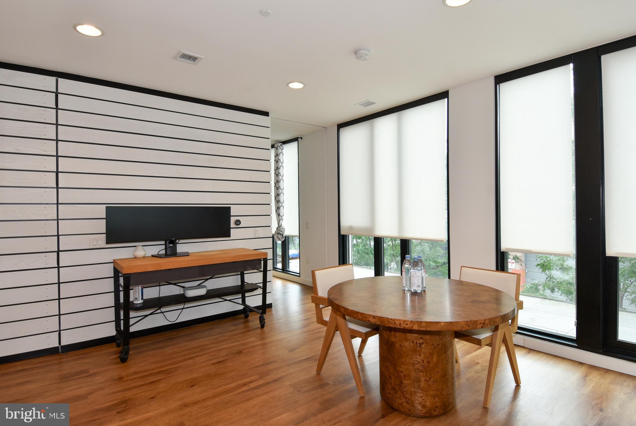 57 N Street Northwest, Unit 225 Washington, DC 20001 - Photo 13 of 38 a living room with furniture and a wooden floor