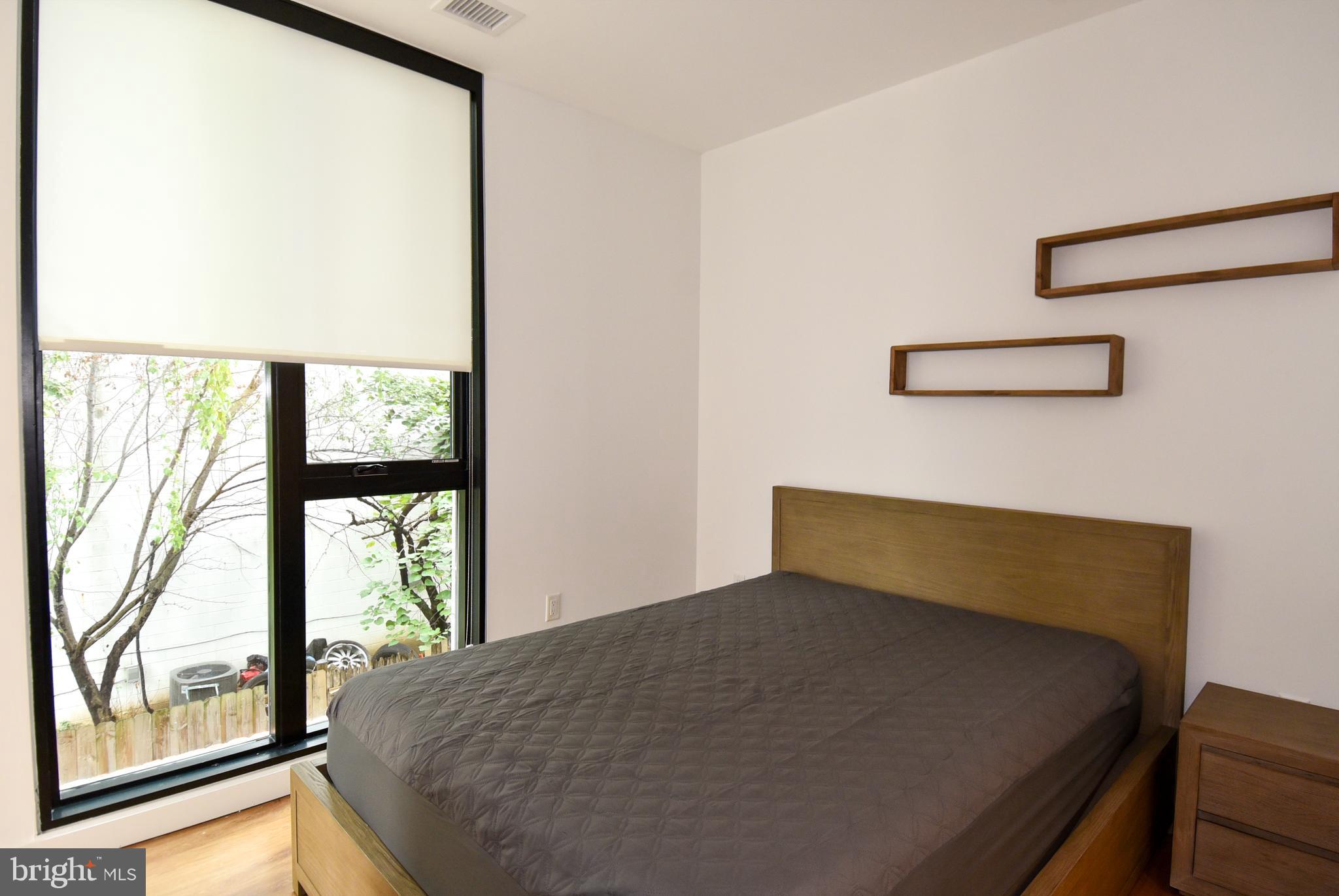 57 N Street Northwest, Unit 225 Washington, DC 20001 - Photo 14 of 38 a bed sitting in a bedroom next to a window