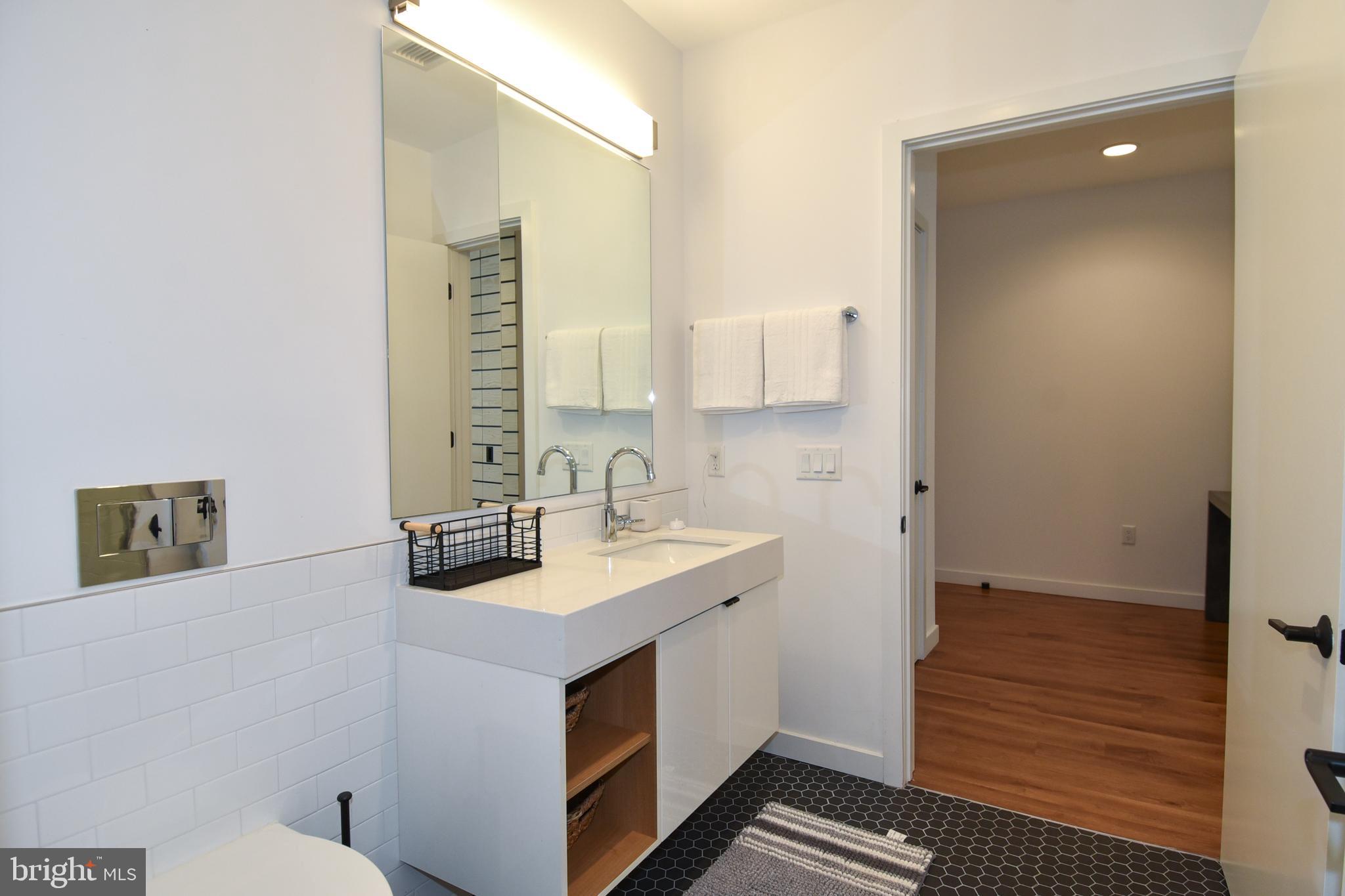 57 N Street Northwest, Unit 225 Washington, DC 20001 - Photo 16 of 38 a bathroom with a sink and a mirror