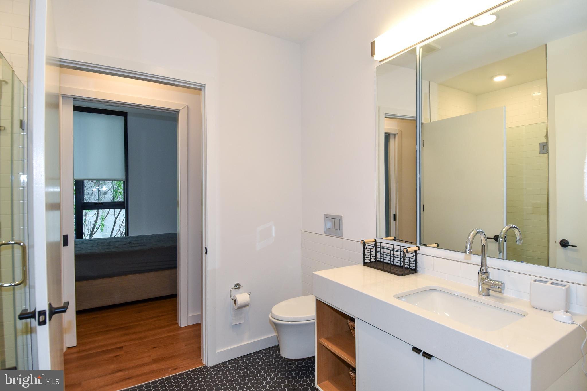 57 N Street Northwest, Unit 225 Washington, DC 20001 - Photo 17 of 38 a bathroom with a sink a toilet and shower