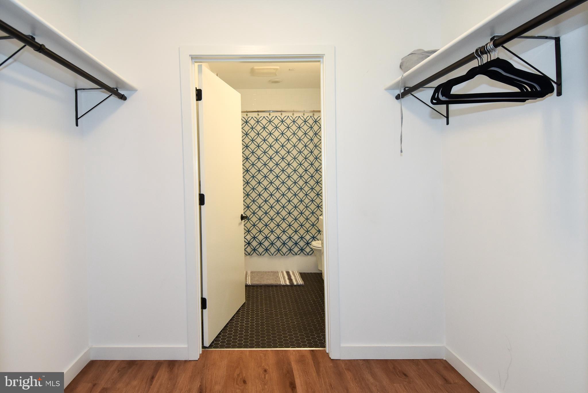 57 N Street Northwest, Unit 225 Washington, DC 20001 - Photo 20 of 38 a view of a hallway with wooden floor and a bathroom