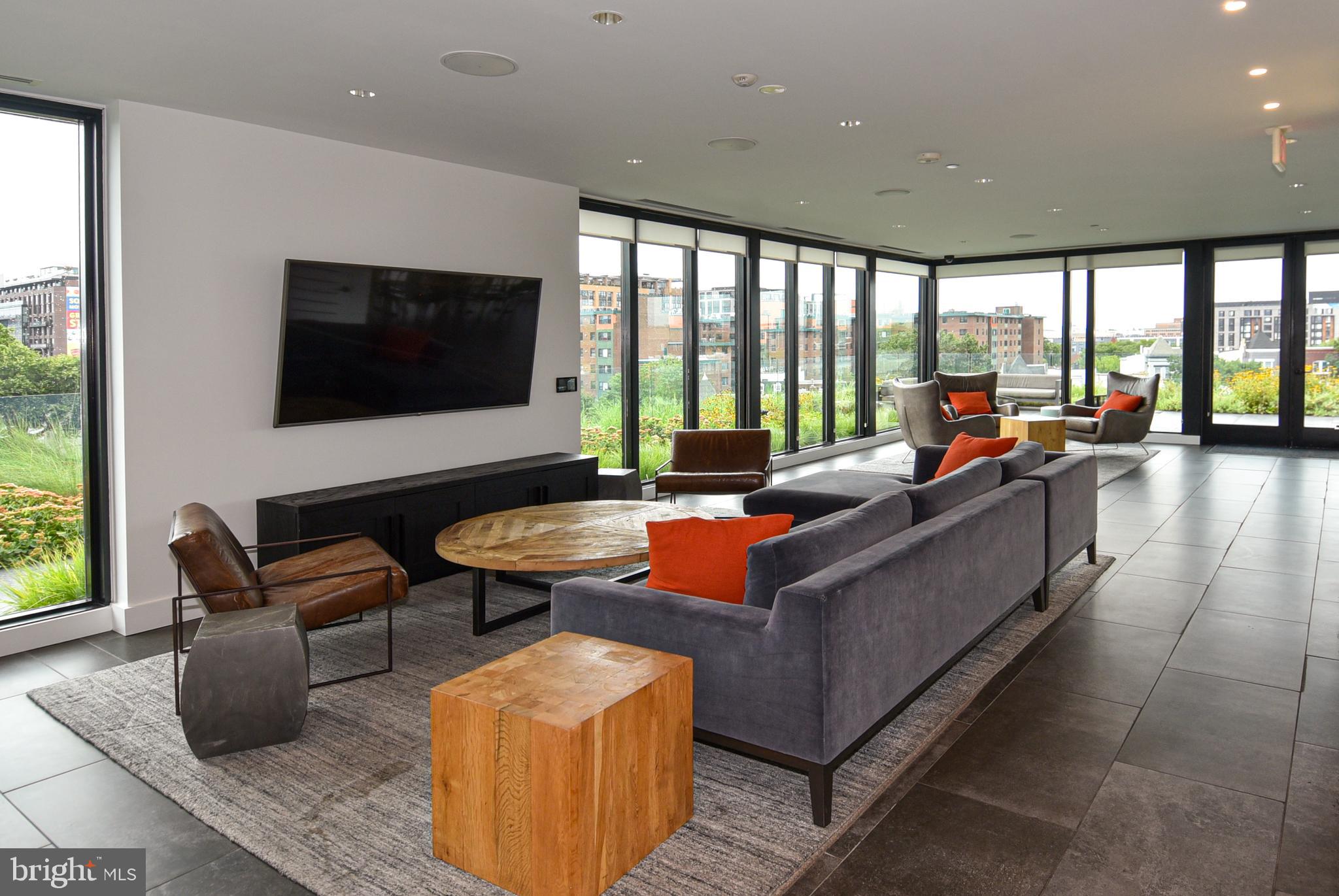 57 N Street Northwest, Unit 225 Washington, DC 20001 - Photo 2 of 38 a living room with furniture and a flat screen tv