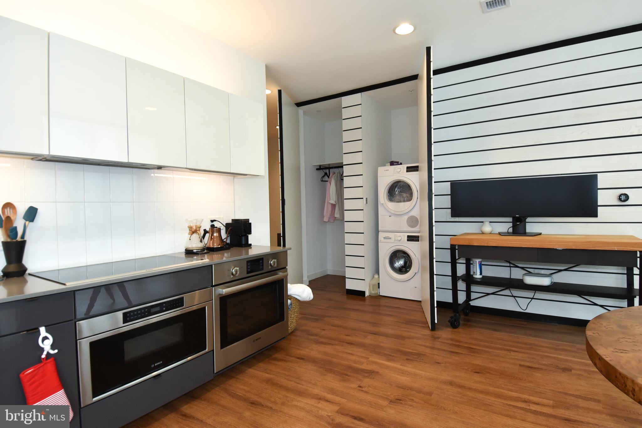57 N Street Northwest, Unit 225 Washington, DC 20001 - Photo 23 of 38 a kitchen with stainless steel appliances granite countertop a stove and a refrigerator