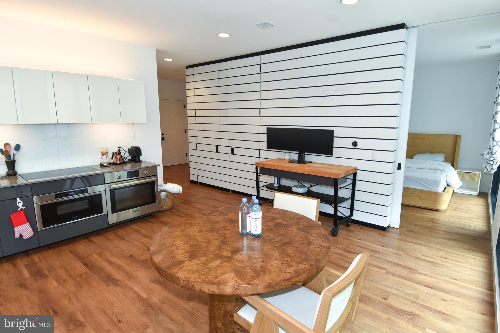 57 N Street Northwest, Unit 225 Washington, DC 20001 - Photo 24 of 38 a room with furniture and wooden floor