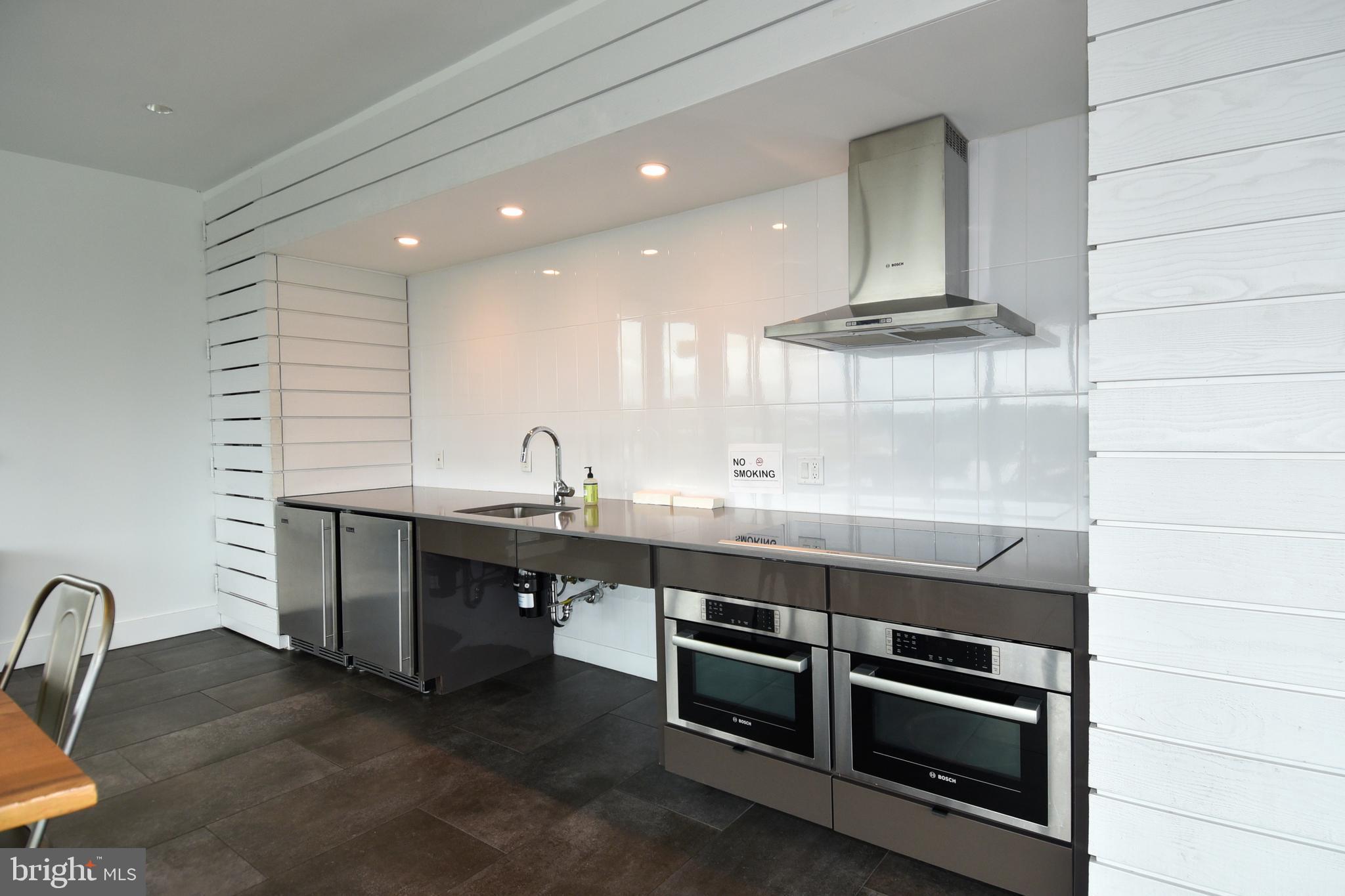 57 N Street Northwest, Unit 225 Washington, DC 20001 - Photo 28 of 38 a kitchen with stainless steel appliances a sink and cabinets