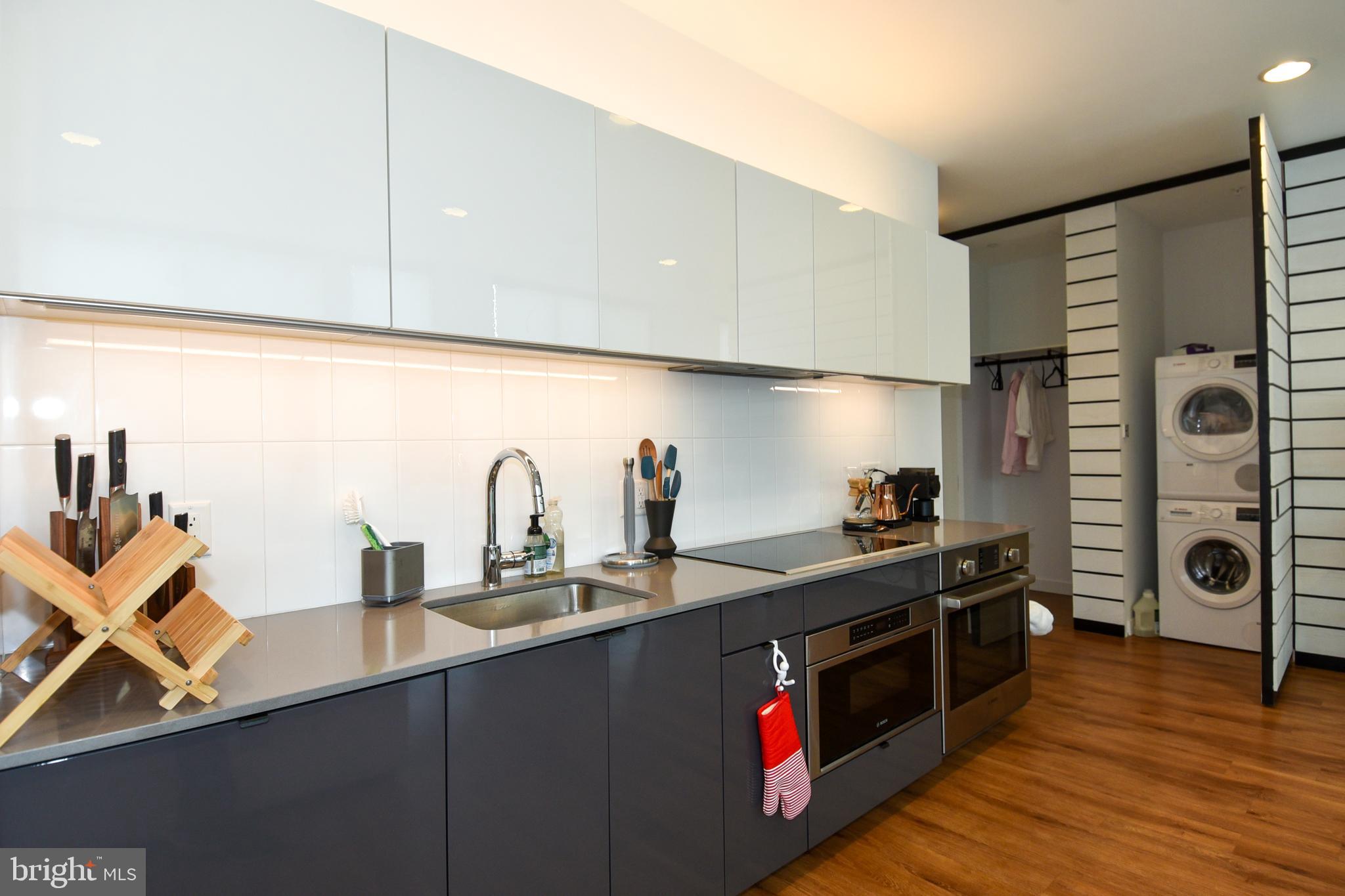 57 N Street Northwest, Unit 225 Washington, DC 20001 - Photo 3 of 38 a kitchen with stainless steel appliances granite countertop a sink and cabinets