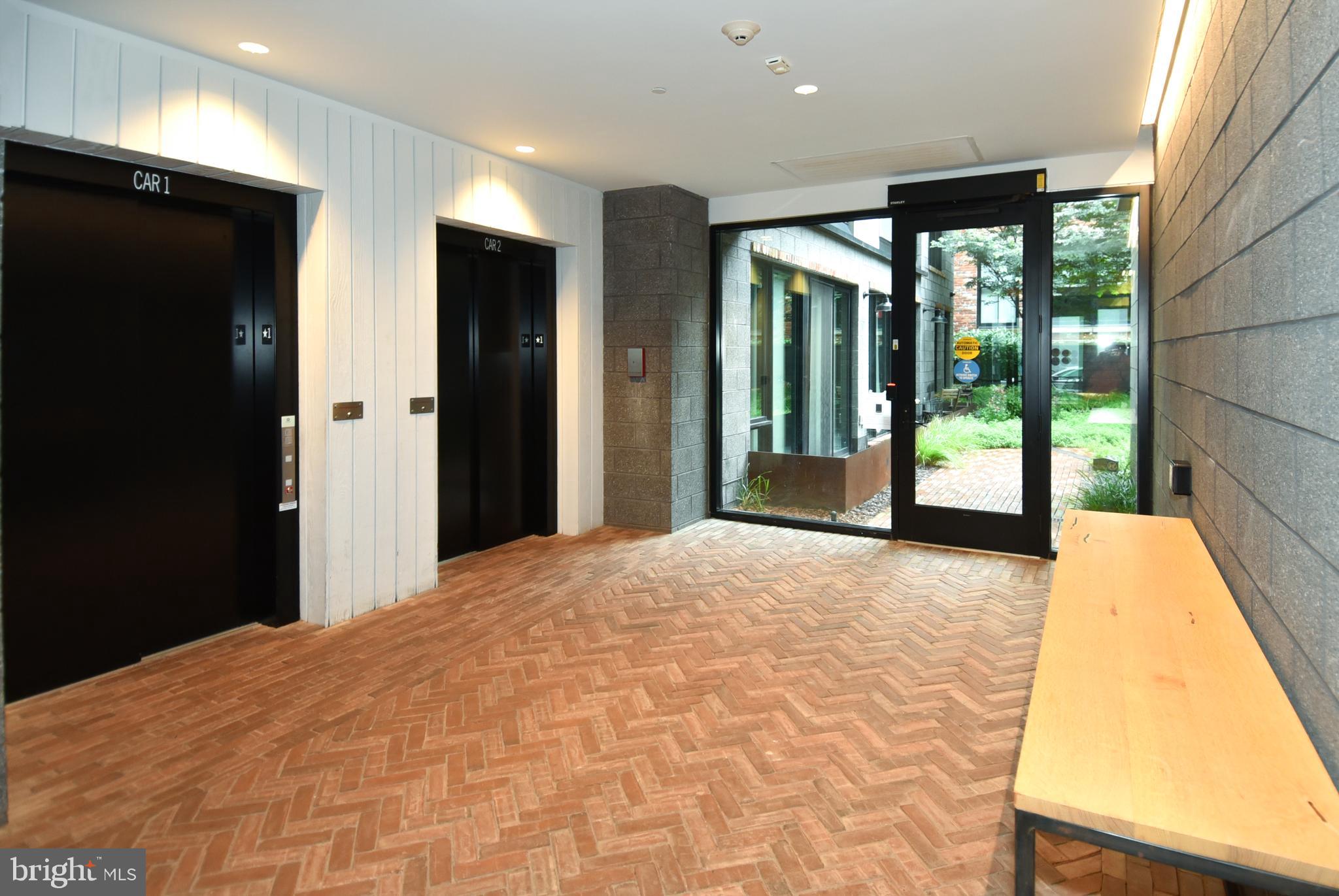 57 N Street Northwest, Unit 225 Washington, DC 20001 - Photo 34 of 38 a large bedroom with a bed and wooden floor