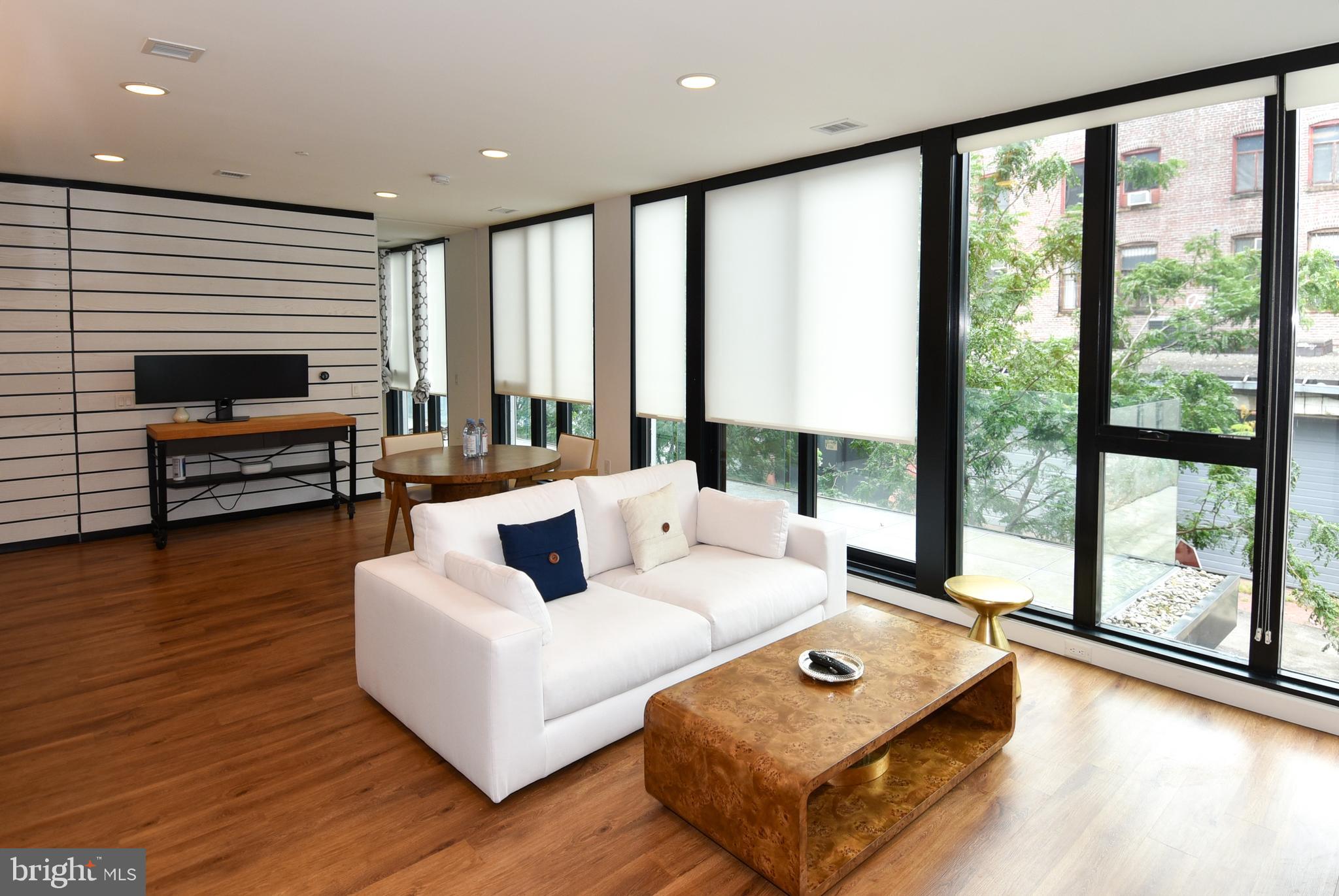 57 N Street Northwest, Unit 225 Washington, DC 20001 - Photo 6 of 38 a living room with furniture and a large window