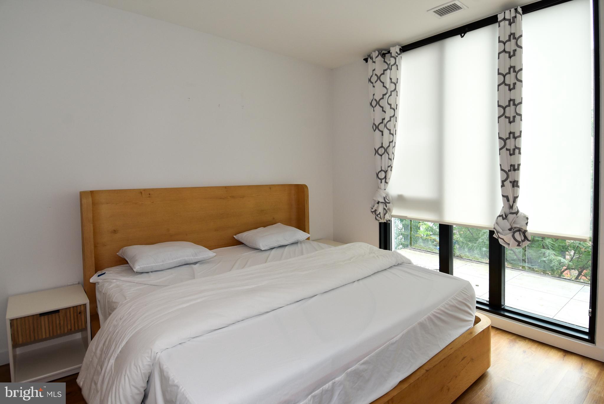 57 N Street Northwest, Unit 225 Washington, DC 20001 - Photo 8 of 38 a bedroom with a bed and a large window