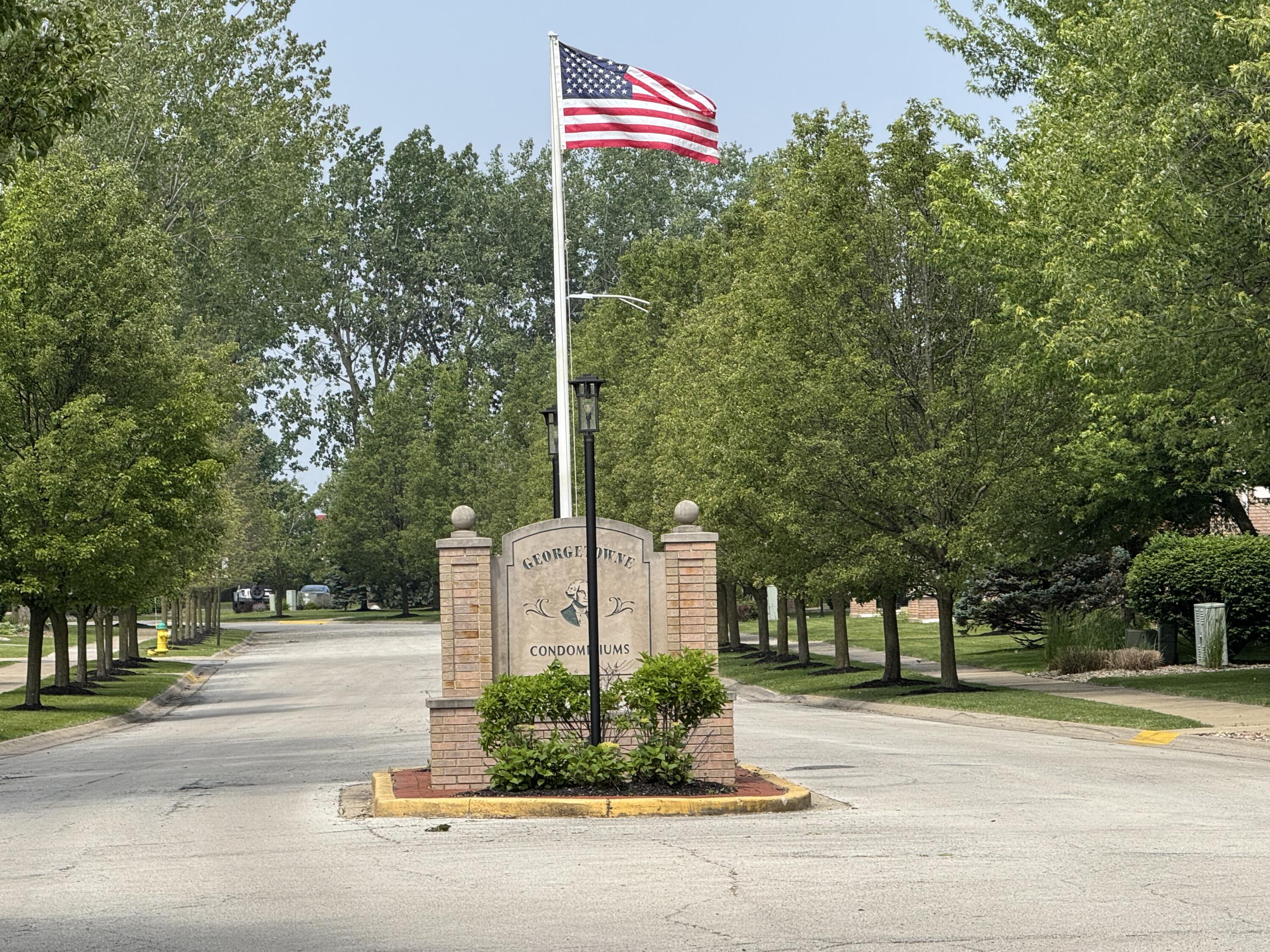 2740 Georgetowne Drive, Unit B1 Highland, IN 46322 - Photo 22 of 22 a street sign on a sidewalk next to a road
