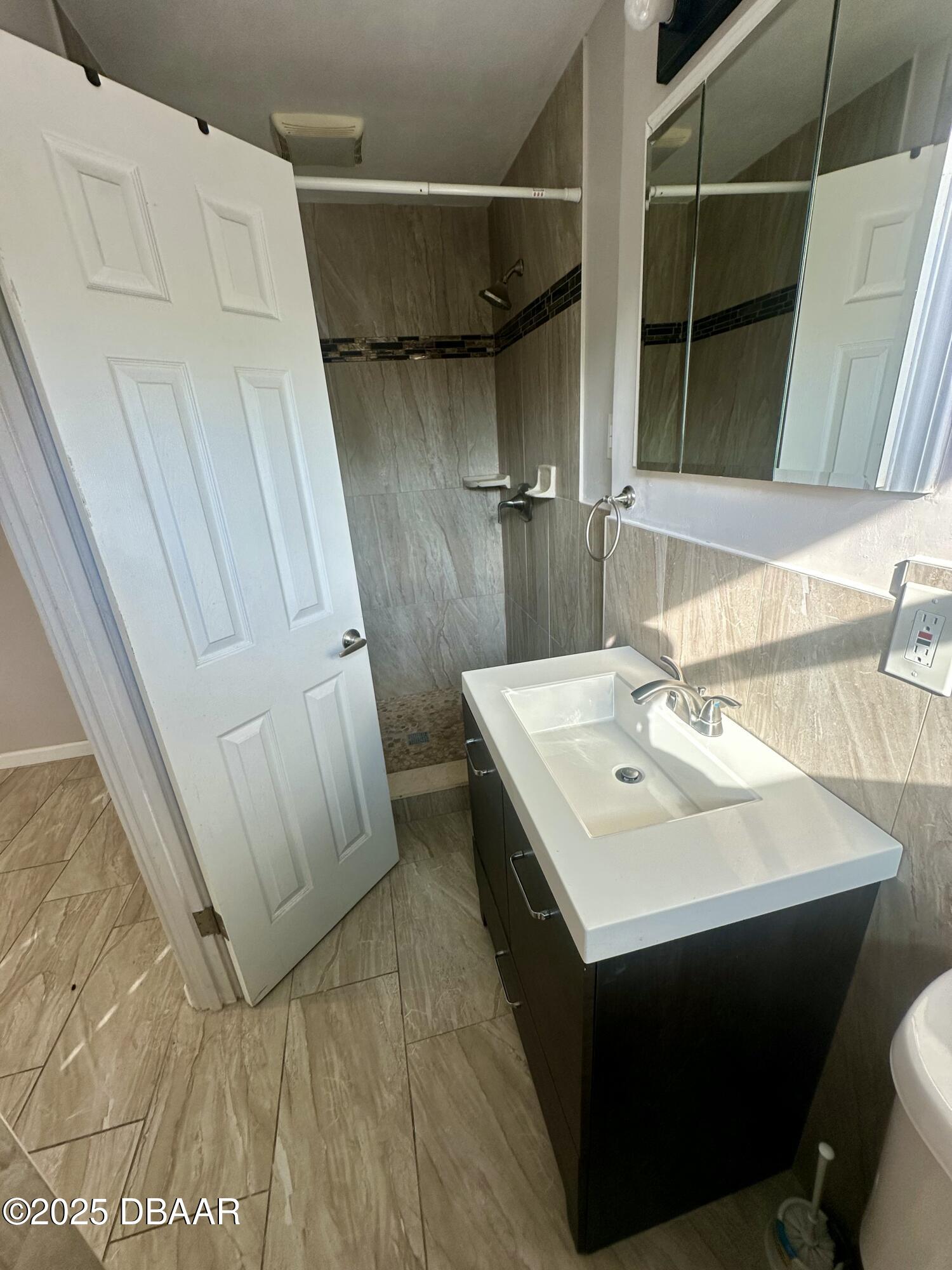 705 Largo Way South Daytona, FL 32119 - Photo 8 of 11 a bathroom with a sink toilet and shower