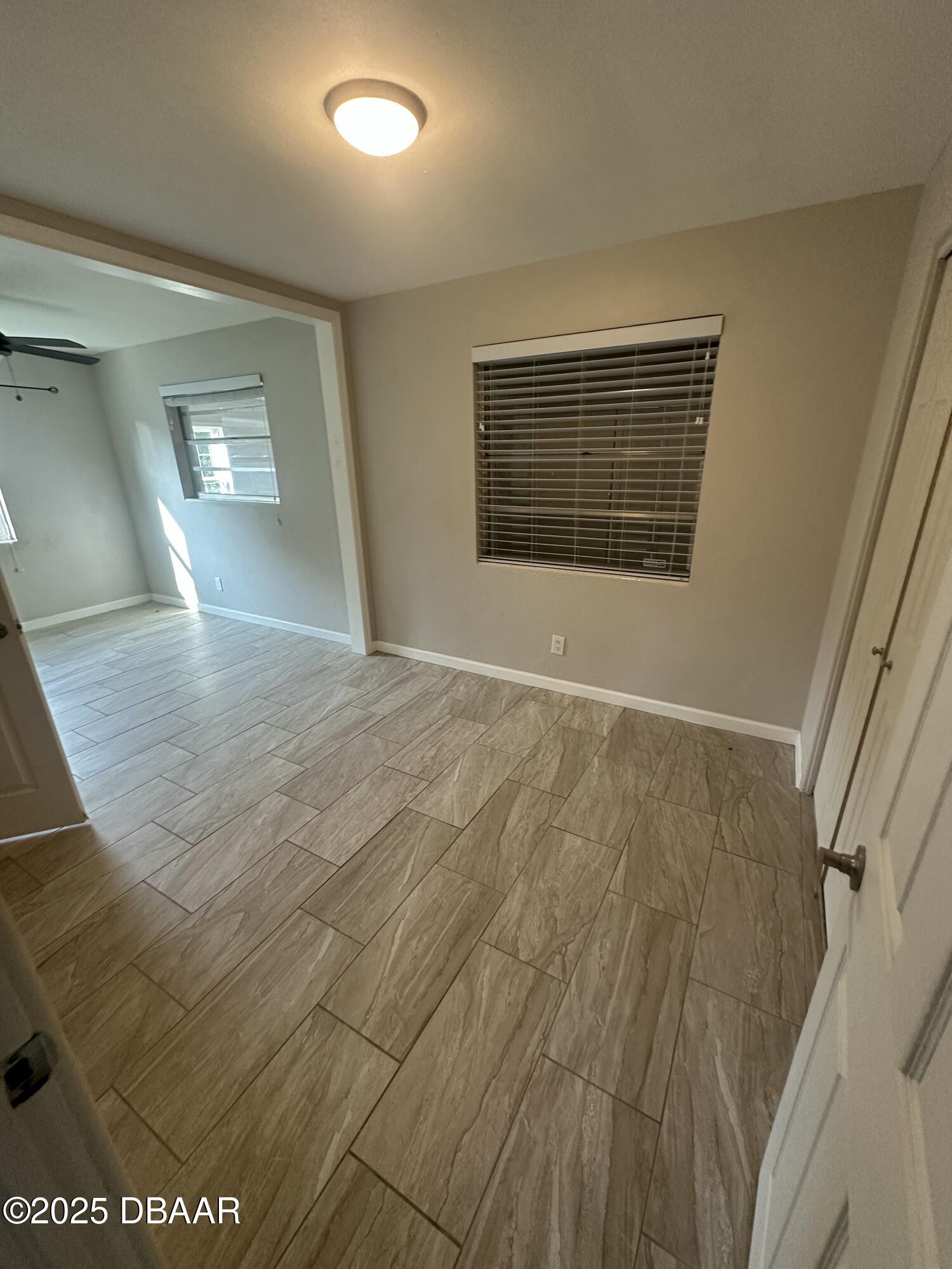 705 Largo Way South Daytona, FL 32119 - Photo 9 of 11 a view of an empty room with wooden floor and a window