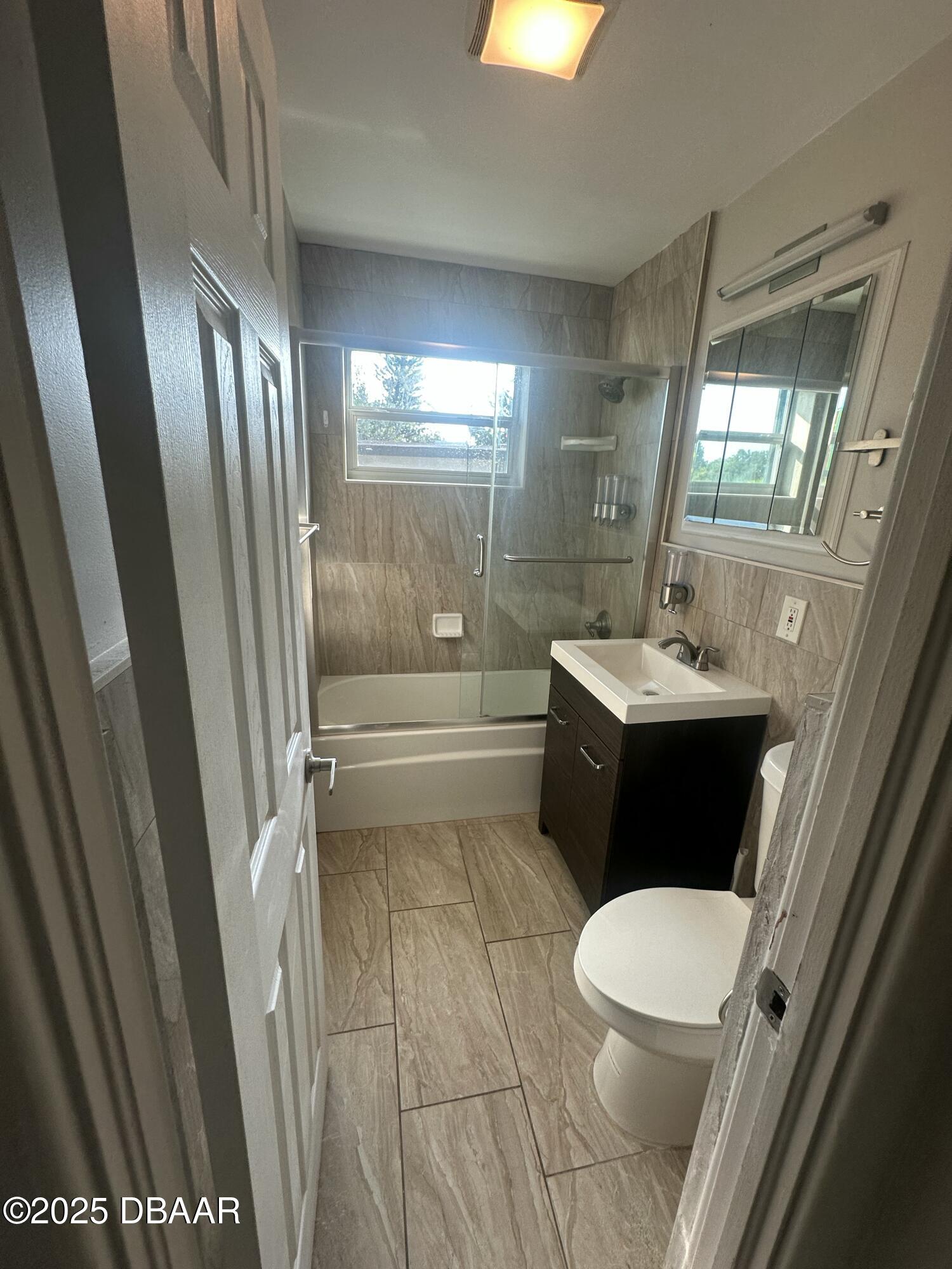 705 Largo Way South Daytona, FL 32119 - Photo 10 of 11 a bathroom with a sink a toilet a tub and shower