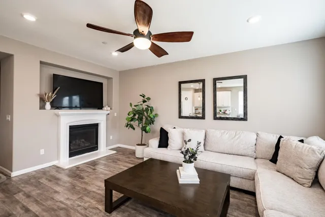 a living room with furniture a fireplace and a flat screen tv