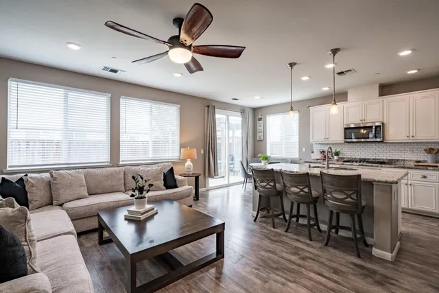a living room with furniture kitchen and a window