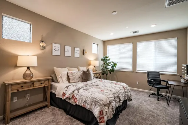 a bedroom with a bed and a table