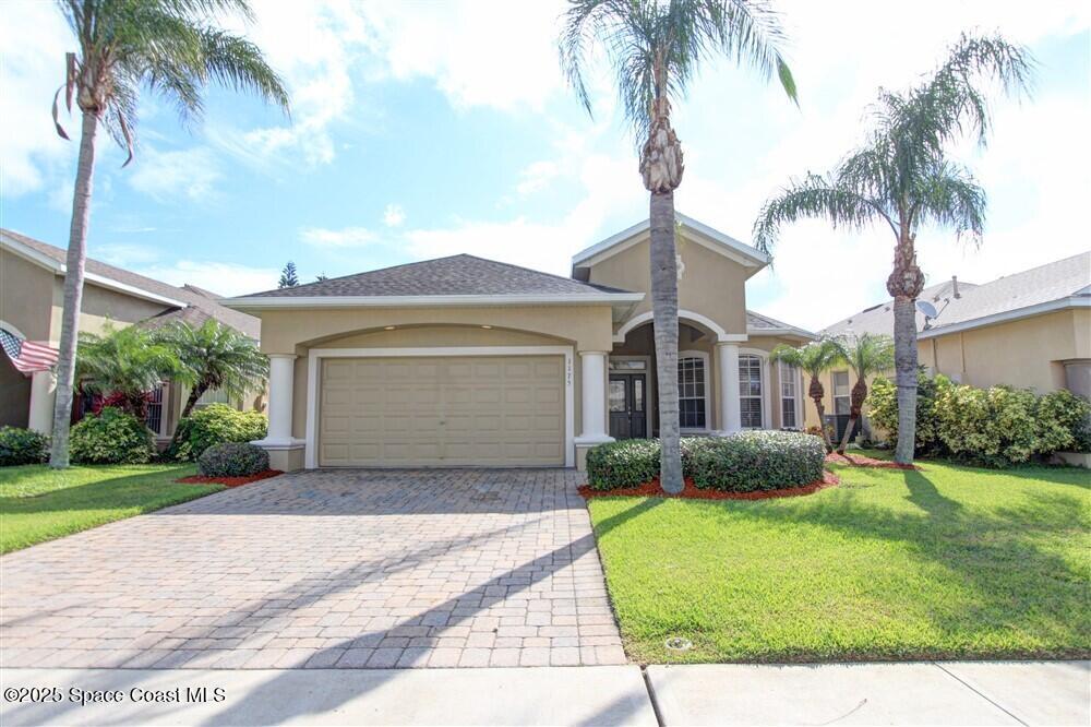 1175 Clubhouse Drive Rockledge, FL 32955 - Photo 1 of 40 a front view of a house with a garden and yard