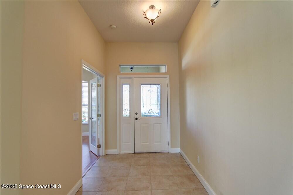 1175 Clubhouse Drive Rockledge, FL 32955 - Photo 8 of 40 an empty room with windows