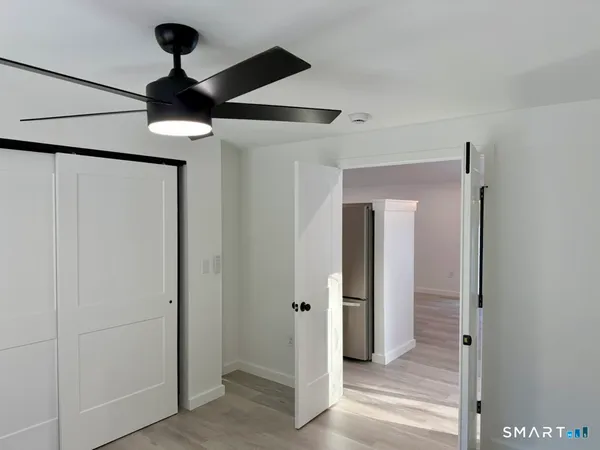 a view of a hallway with wooden floor