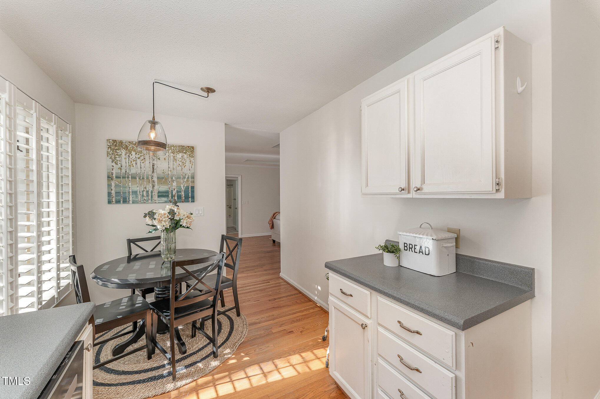 25 Sandstone Ridge Drive Durham, NC 27713 - Photo 10 of 33 a kitchen with a table chairs and white cabinets