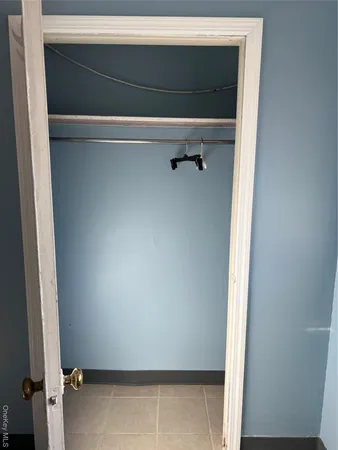 a view of a room with rack and white walls